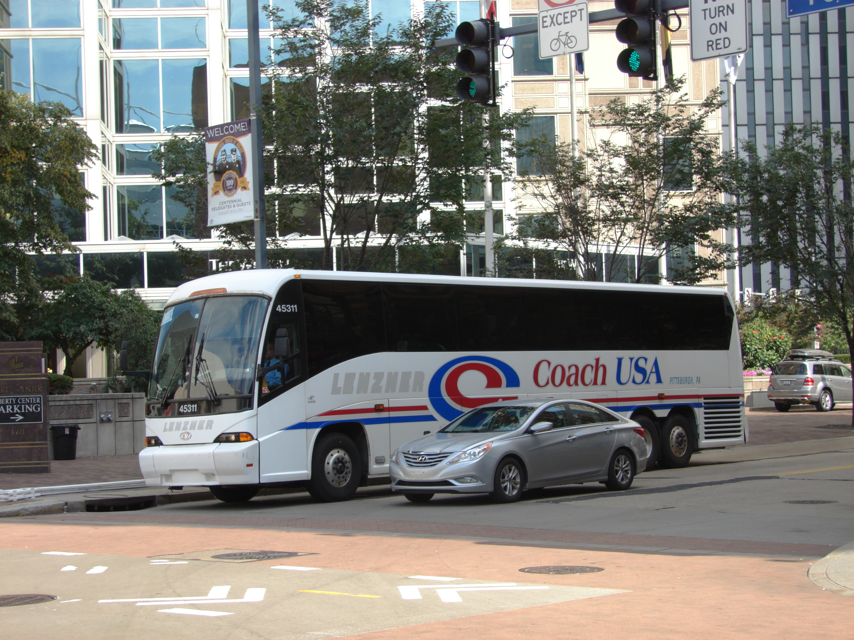 A Coach USA motorcoach at a downtown Pittsburgh intersection