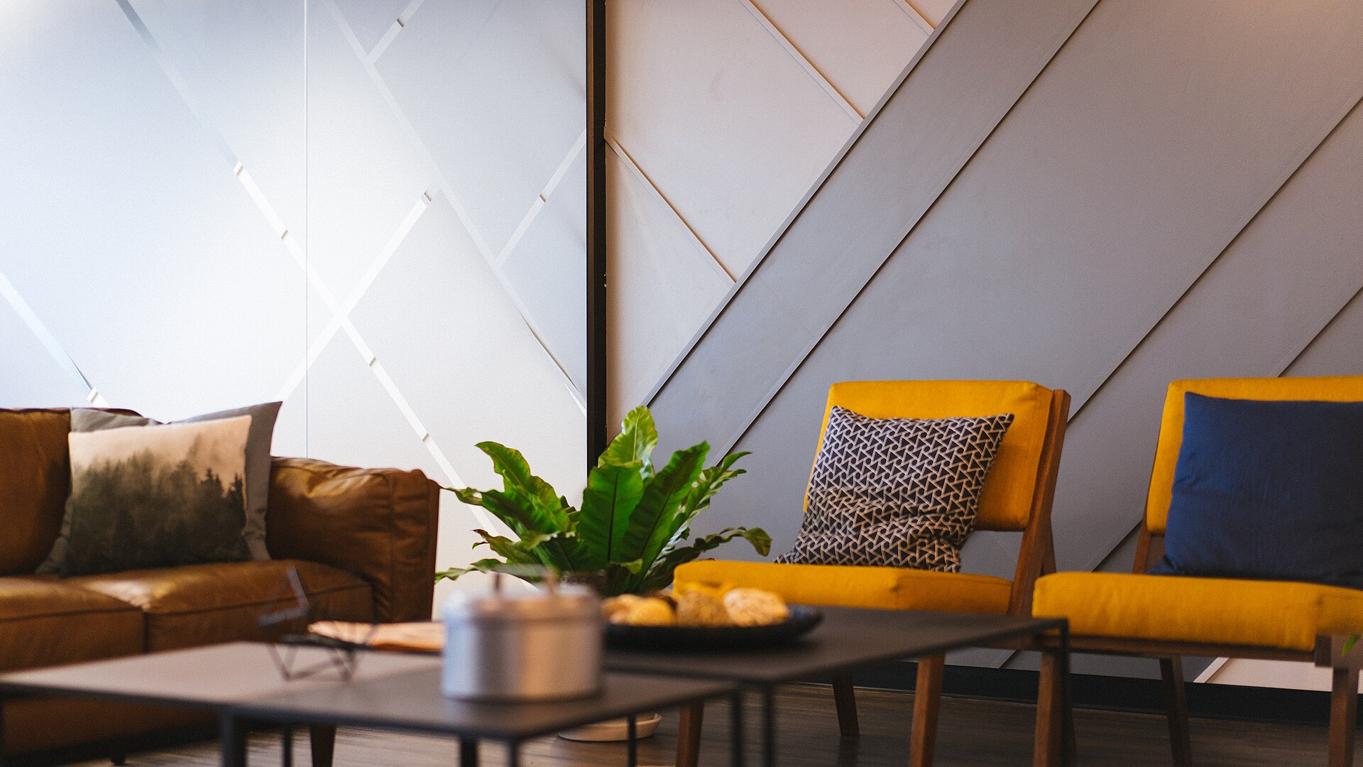 Casual meeting room with sofas and yellow chairs