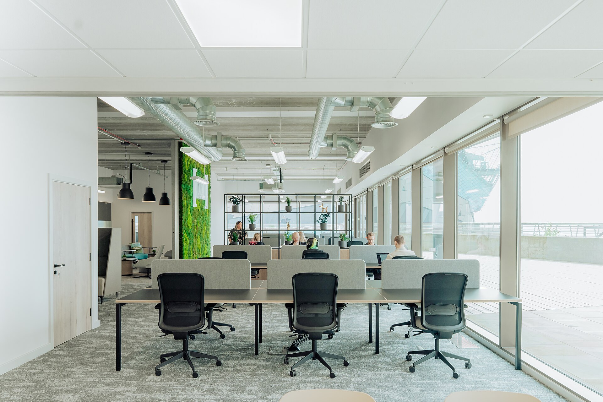 Bright open-plan office with a team working at shared desks